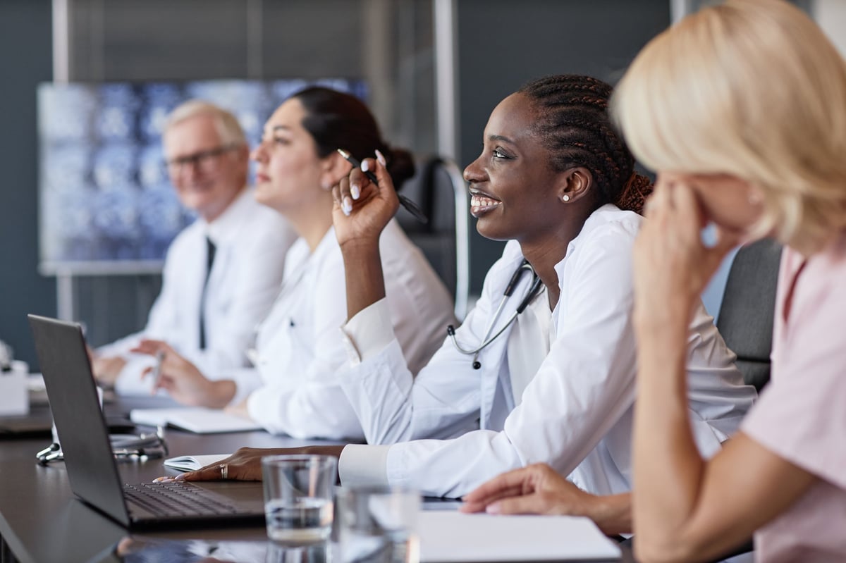 Physician engaging in a professional discussion during a medical seminar