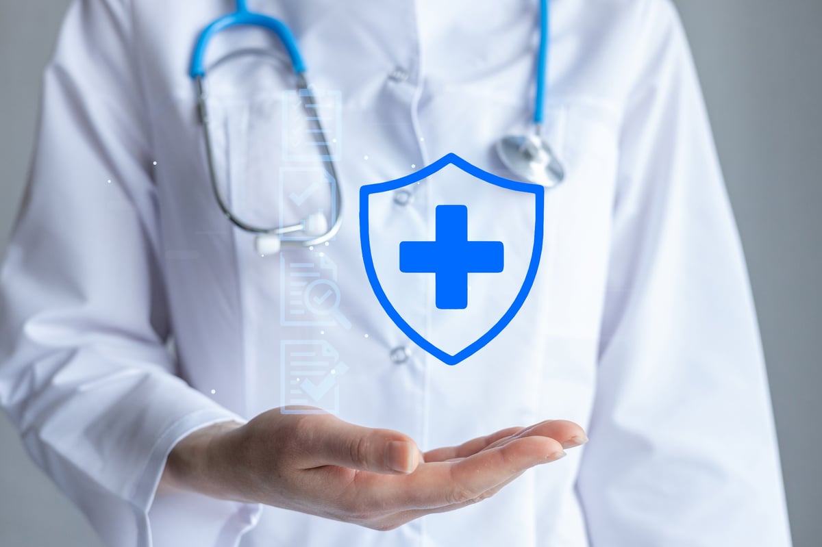 Medical professional in a white coat holding a stethoscope